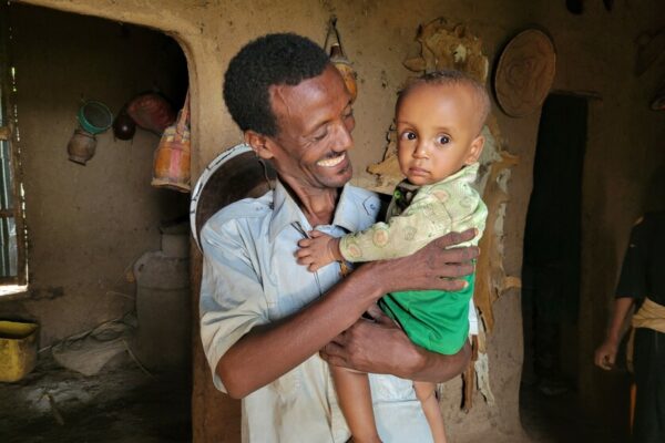 Women in Ethiopia normally spend around 16 hours a day with household chores such as fetching water, firewood, cleaning, cooking, crop harvest and looking after the children. These tasks are traditionally seen as the role of a woman and wife. “It takes a lot of time. I used to do this alone, just like every other wife in our community,” says Wubare. Wubare’s husband, Wagnew, 42, is part of a CARE SAA group where they talked about division of labor. “If we divide the workload, then women have more free time to help the family economically and have more time to take care of the children and support them. So, we decided to change the norm and men take on a new role now,” says Wagnew. Next to cooking breakfast for his family, his favorite task in the household is looking after the baby. “I am very thankful, and I am very relieved,” says Wubare.