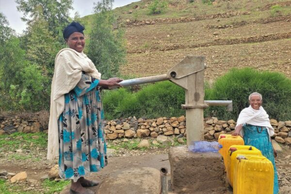 Bosse, 40, and Yalga, 70, fetching water at a water pump, installed by the community together with CARE.

Climate change is affecting communities in Ethiopia. The country is facing the worst drought in the last 40 years. Women and girls have to walk long distances to find water. Livestock are dying and the fields are not producing enough crops. Livelihoods are at risk. 
 
It is the women and girls that need to go and find water. Due to the drought, it can take up to two hours of walking to find a source. Girls drop out of school, because they have to walk the whole day to fetch water for their families. 
       
After walking for hours, the women and girls find a small water hole or a stream that still has water. The water is dirty. Livestock also drink from it. The water is full of their feces and excrements. “Little worms live in the water, that suck the blood out of your mouth. Drinking water from an unprotected source made us very ill. Diarrhea and vomiting are the most common,” explains Bosse, 40. Drinking contaminated water full of bacteria has serious health effects that can compromise the immune system severely, cause infections and sometimes even lead to death. 
   
That is why it is crucial to have access to a protected water source. In water projects, CARE supports the communities by building wells and water pumps close to the villages. The area around the water pump is protected by the community. “We plant trees and other plants. With gabions we build barriers to control the water flow. No livestock is allowed to enter this area. Before we had this protected environment, we had enough water for a month. But now the ground water is rising, and we already have enough for six months. We understand the importance and will continue planting more trees to have enough water for the whole year,” explains Bosse.


“Having access to water changed our community. Women have less household chores and girls can go back to school and receive an education instead of fetching water the whole day. We changed our mindset. Now we treat the trees in the protected environment like our children,” reflects Yalga, 70. 