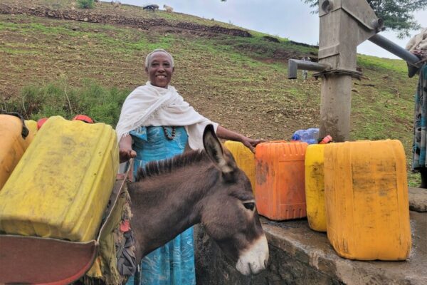 Yalga, 70, fetching water at a water pump, installed by the community together with CARE.

Climate change is affecting communities in Ethiopia. The country is facing the worst drought in the last 40 years. Women and girls have to walk long distances to find water. Livestock are dying and the fields are not producing enough crops. Livelihoods are at risk. 
 
It is the women and girls that need to go and find water. Due to the drought, it can take up to two hours of walking to find a source. Girls drop out of school, because they have to walk the whole day to fetch water for their families. 
       
After walking for hours, the women and girls find a small water hole or a stream that still has water. The water is dirty. Livestock also drink from it. The water is full of their feces and excrements. “Little worms live in the water, that suck the blood out of your mouth. Drinking water from an unprotected source made us very ill. Diarrhea and vomiting are the most common,” explains Bosse, 40. Drinking contaminated water full of bacteria has serious health effects that can compromise the immune system severely, cause infections and sometimes even lead to death. 
   
That is why it is crucial to have access to a protected water source. In water projects, CARE supports the communities by building wells and water pumps close to the villages. The area around the water pump is protected by the community. “We plant trees and other plants. With gabions we build barriers to control the water flow. No livestock is allowed to enter this area. Before we had this protected environment, we had enough water for a month. But now the ground water is rising, and we already have enough for six months. We understand the importance and will continue planting more trees to have enough water for the whole year,” explains Bosse.


“Having access to water changed our community. Women have less household chores and girls can go back to school and receive an education instead of fetching water the whole day. We changed our mindset. Now we treat the trees in the protected environment like our children,” reflects Yalga, 70. 