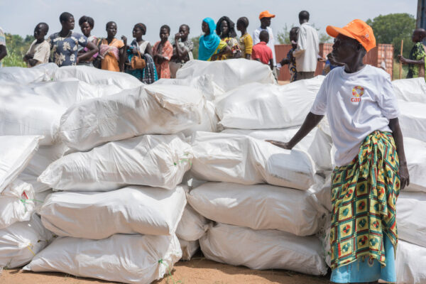 Residents of Torit, Eastern Equatoria, South Sudan wait in line to receive relief items. CARE is providing items including soap, tarpaulins, blankets, jerry cans, mats, and cloth to 1,500 households who were affected by the fighting in July 2016. Most of their homes were burnt and looted. Most people lost everything from clothes to cooking equipment and have had to borrow or share.

Background: CARE has been operating in Southern Sudan since 1993, providing humanitarian relief to internally displaced people in Western Equatoria, Jonglei State and Upper Nile. South Sudan has the highest inflation rate in the world, at over 700%. The ongoing civil war has led to wide spread insecurity, hunger, and exploitation of women and girls. 1.6 million people are currently displaced and 5.1 million people are in need of aid. CARE is working in Health, Nutrition, Food and Security, Livelihoods, Peace Building and Gender.  The images were taken in and around Mankien, Unity State, South Sudan during November 2016.